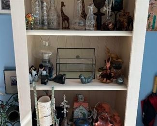 Tall, slim Book case. Picture show cases crystal decanters and carved rock creationsl