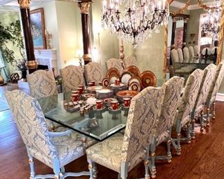 Custom 5’ x 10’ glass topped dining table resting on antique column halves.  There are 14 chairs - 10 side chairs, 4 armchairs.  They are stunning!