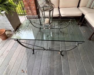 Heavy iron and glass coffee table.  This coffee table was originally inside, but we took it outside to have more room.  It’s perfect indoors and out!