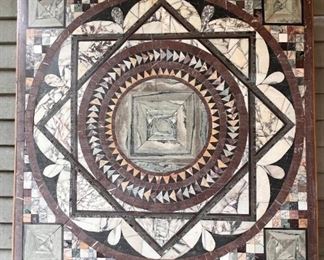 The wall hanging was originally the top to the breakfast room table.  When it arrived, it was cracked.  The owners had it repaired. Instead of shipping it back to Italy, the owners had steel mounts made and made a wall hanging.  It’s pretty great!