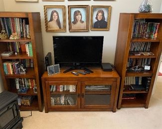 Book cases, TV stand, flat screen TV, books, Disney VHS, dvd’s