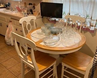 This is a quaint kitchen table and chair set, perfect for a breakfast nook.