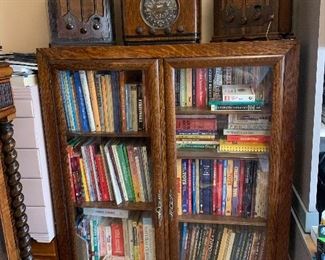 Beautiful early book / display case. Multitude of vintage books, collecting books, antique research books. Antique tube radios, Zenith, RCA, Atwater Kent