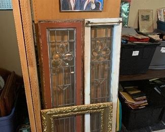 leaded glass windows, rust colored on one side, white with a curtain hanger on the other