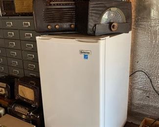 Mini fridge, tube radios, metal parts drawers