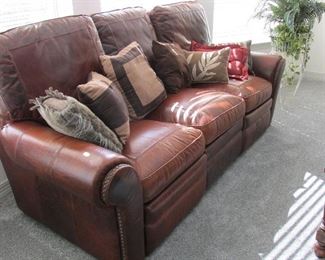 Two real leather sofas one is a sleeper and the other has a recliner at either end at armrest. Nice buy!