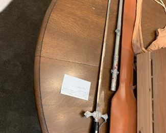 #98	Ant. Ceremonial Knights Temper w/Scabbard and Leather Sword Carrying Case.  Bears owner inscription 	 $275.00 			
