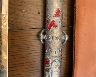 #98	Ant. Ceremonial Knights Temper w/Scabbard and Leather Sword Carrying Case.  Bears owner inscription 	 $275.00 			
