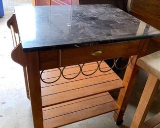 #138	Marble Top Rolling Island w/wine rack & 1 drawer  & 2 shelves   24x30x36	 $120.00 			
