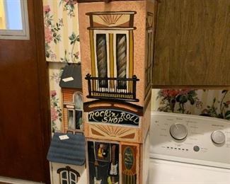 #168	Wood Painted Rock N Roll Shop house - 27" Tall	 $25.00 			
