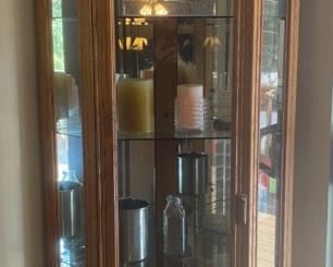 Corner Curio Cabinet With Clocks Vases And Candles