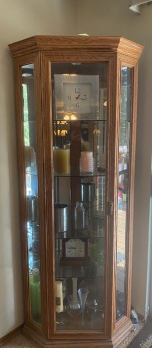 Corner Curio Cabinet With Clocks Vases And Candles