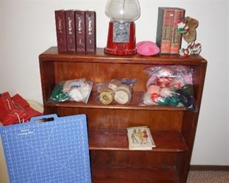 bookcase, gumball machine, sewing and craft items