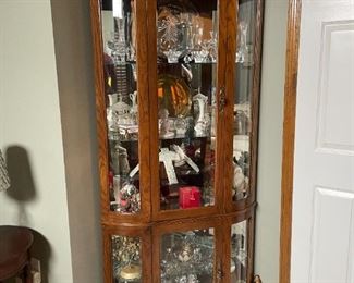 . . . nice corner curio cabinet loaded with treasures