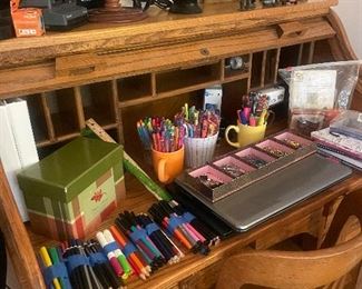 Roll top desk
Many colored pencils and adult coloring books