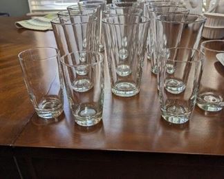 12 clear drinking glasses and 4 smaller glasses.