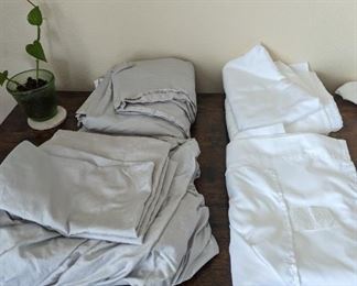 2 sets of XL twin flat white sheets. 2 sets of grey twin sheet sets.