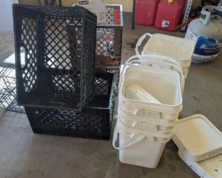 Four crates and 5 white buckets.
