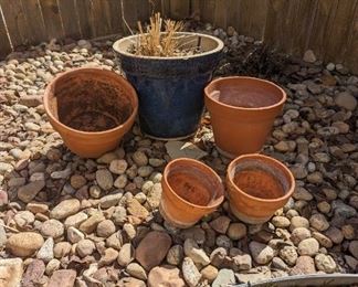Two large blue pots and 4 smaller terracotta pots. Soil does come in the blue pots.