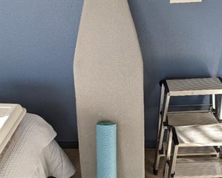 Ironing board and yoga mat.