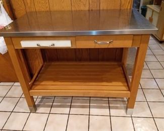 Very cute kitchen island with pull out cutting board