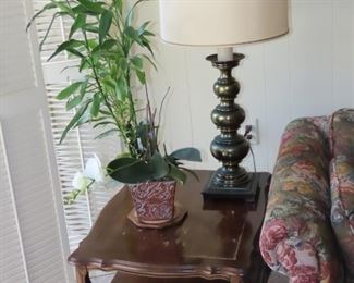 End table with drawer and tall table lamp.