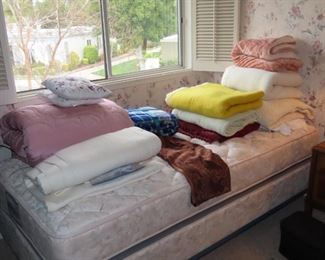 Second bedroom area. Twin bed, linens, blankets.