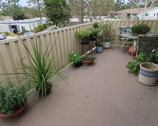Balcony with plats and patio set.