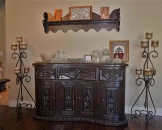 Wrought iron candelabras and a rustic Central American buffet