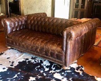 TWIN LAKES DOUBLE SIDED LEATHER SOFA

•  Entertaining double-sided sofa – Made in the USA!
•  Hardwood frame
•  Leather over high-density foam cushioning
•  Tufted dark saddle brown leather
•  Finished with brass nail-head trim and wood bun feet
•  Springs are hand tied to the frame and surrounding springs at eight points for lasting comfort and stability
•  Approx 74"L x 63"D x 30"T; seat, 22"D x 17"T 
•  Weight, approximately 250 lbs boxed

About Old Hickory Tannery
Founded more than 50 years ago, Old Hickory Tannery is still family owned and operated in Hickory, North Carolina. Although the company's name reflects its original focus on fine leather upholstery, Old Hickory is now equally well known for fabric-covered seating. Its range of styles is impressive, from dramatic Duncan-Phyfe-style sofas to graceful Queen Anne armchairs, claw-footed tub chairs, feminine full-skirted settees, and sleek slipper chairs. Old Hickory's craftsmen bring an abundance of expertise to their work; so