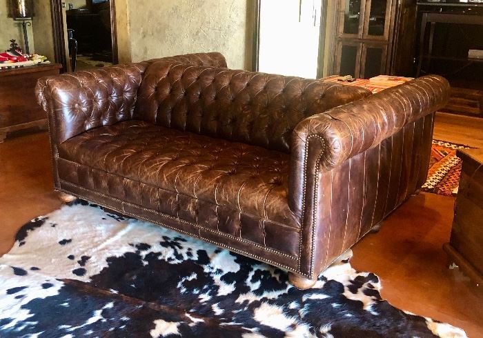 TWIN LAKES DOUBLE SIDED LEATHER SOFA

•  Entertaining double-sided sofa – Made in the USA!
•  Hardwood frame
•  Leather over high-density foam cushioning
•  Tufted dark saddle brown leather
•  Finished with brass nail-head trim and wood bun feet
•  Springs are hand tied to the frame and surrounding springs at eight points for lasting comfort and stability
•  Approx 74"L x 63"D x 30"T; seat, 22"D x 17"T 
•  Weight, approximately 250 lbs boxed

About Old Hickory Tannery
Founded more than 50 years ago, Old Hickory Tannery is still family owned and operated in Hickory, North Carolina. Although the company's name reflects its original focus on fine leather upholstery, Old Hickory is now equally well known for fabric-covered seating. Its range of styles is impressive, from dramatic Duncan-Phyfe-style sofas to graceful Queen Anne armchairs, claw-footed tub chairs, feminine full-skirted settees, and sleek slipper chairs. Old Hickory's craftsmen bring an abundance of expertise to their work; so
