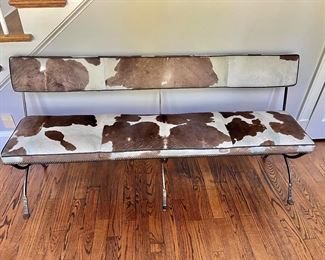 Cow hide bench with hammered iron legs 33''H by 70''W by 19''D. Seat height 20''