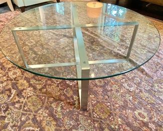 Glass and chrome modern coffee table on Turkish Oushak