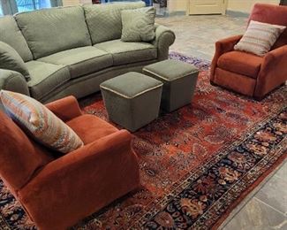 downstairs sofa and ottomans, pair of orange upholstered recliners, oriental rug