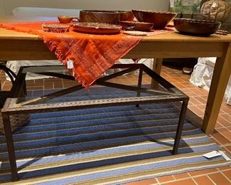 Hand wrought welded steel indoor outdoor coffee table. the included glass has on corner chip. 29 wide by 40 long by 17 high