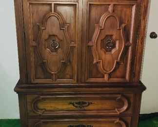 Chest of drawers.  Doors open to drawers