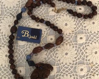 B Gould hand made necklace 
Sodalite knack beads, fossils , precious woods and Chinese porcelain 