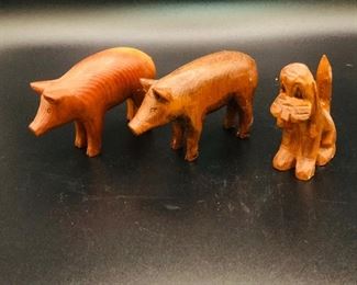 Hand carved pigs and dog