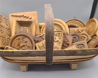 Wooden molds sitting inside of a "The Truggery" English trug basket