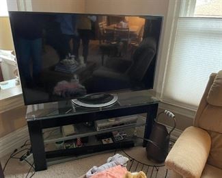 . . . large flat-screen TV and TV stand