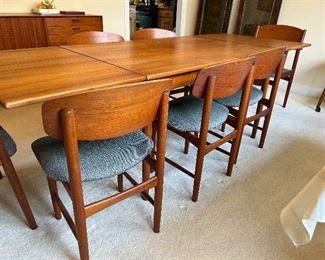 	#1	Vintage Danish teak modern dining table with 2 pull out leaves and 6 chairs + one extra.  51-94x35x29	 $600.00 