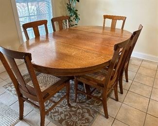 	#58	Oak pedestal table with 6 chairs and 3 leaves. As is one chair 44-81x45x30	 $300.00 				