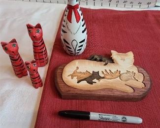 Wooden cats. One is a puzzle, white one is nesting set
