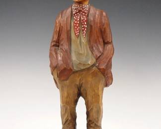 Lot 1: A mid 20th century German clockwork "Whistler" figure.  Carved wooden automaton figure whose head moves and whistles a tune when activated via Brass key wind movement with bellows.  Original painted finish.  Minor wear, working when cataloged.  13 1/4" high overall.  ESTIMATE $400-600
