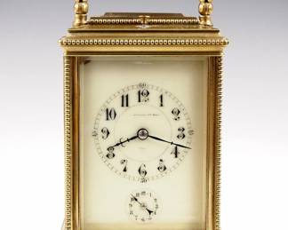 Lot 9: A turn of the century French Carriage clock.  8-day movement with Petite Sonnerie strike and Grand Sonnerie repeat, porcelain dial with Arabic numerals and subsidiary alarm set dial.  Brass case with beaded detail, folding handle, molded top and base, and beveled glass panels.  Minor wear, small flake in dial corner, dent in rear base molding, running when cataloged.  6 1/4" high overall, plus case.  ESTIMATE $600-800
