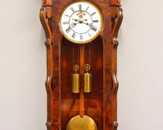 Lot 27: A turn of the century Lenzkirch two weight Regulator wall clock.  8-day weight driven time and strike movement with two part porcelain dial, Roman numerals and visible escapement, serial #430878 indicates a production date of 1877.  Burl Walnut Serpentine case with arched crest and turned finials over a shaped door with serpentine pilasters and lower shaped bracket drop.  Older refinishing with minor wear, faint dial hairlines, restored finials, running when cataloged.  51" high overall.  ESTIMATE $1,000-1,500

