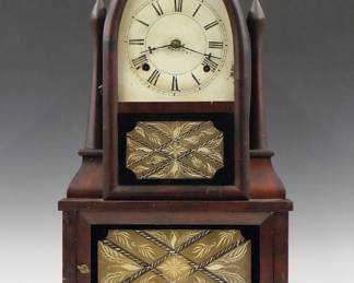 Lot 28: A 19th century Birge & Fuller Wagon Spring Shelf clock.  30-hour time and strike movement with "Wagon Spring" power, painted metal dial with Roman numerals.  Unusual Mahogany "Beehive" form case with turned "Candles", arched upper door with original clear dial glass and reverse painted lower and bottom door glass.  Paper label 80% intact.  Old dry finish, minor dial damage, not running when cataloged.  21 1/2" high overall.  ESTIMATE $1,000-1,500
