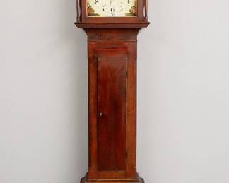 Lot 35: An early 19th century Pennsylvania Tall clock.  8-day time and strike movement with sweep second hand and center calendar hand, painted Iron dial with upper moon phase and Arabic numerals, marked "Christian Hall, Lititz".  Cherry case with broken arch crest and turned finials over a shaped dial door flanked by turned columns, over a rectangular waist door and a paneled base with flared feet.  Older refinishing with minor wear, restored feet and finials, dial touch-ups, running when cataloged.  103 1/2" high overall.  ESTIMATE $1,500-2,500
