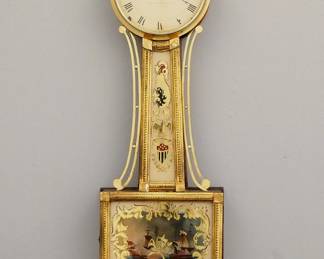 Lot 37: A 19th century American Presentation Banjo clock.  8-day Brass, weight driven time only movement with painted Iron dial and Roman numerals marked "Aaron Willard Jr., Boston".  Gilded Mahogany case with pierced Brass arms, Brass dial door with convex glass over reverse painted throat and lower "Constitution & Guerriere" door glasses, shaped drop with fluted detail.  Original Gilding with wear and some loss, restored painted glasses, replaced pendulum, finial and plinth, running when cataloged.  40 1/2" high overall.  ESTIMATE $1,000-1,500
