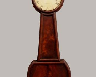 Lot 44: An early 19th century American striking Banjo clock.  8-day weight driven time and strike 4-pilar movement with arched top plates, painted Iron dial and Roman numerals, signed "No. 1838, A Willard Jr".   Mahogany case with turned finial over a circular Mahogany dial door with convex glass, tapered throat panel shaped lower door with molded edges and Crotch Mahogany panels over a shaped lower drop.  Older finish with good color, finial re-painted, dial wear and touch-ups, running when cataloged.  39" high overall.  ESTIMATE $2,000-3,000

